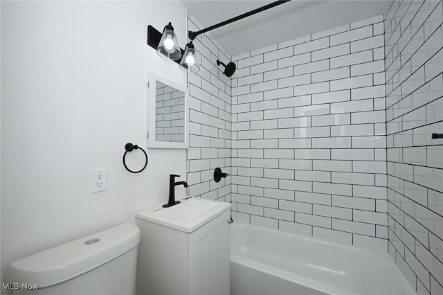 bathroom with toilet, vanity, and tub / shower combination