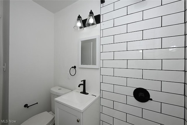 bathroom with toilet and vanity