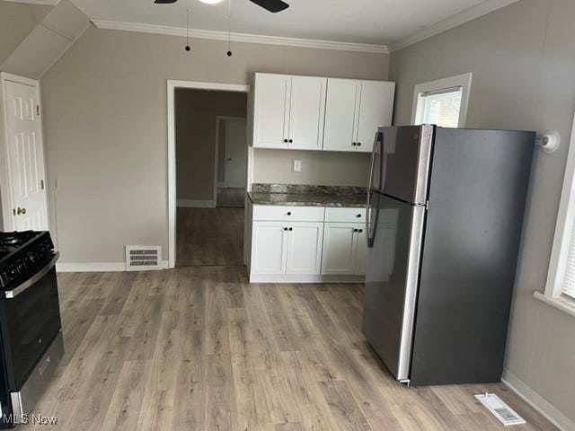 1900 Lamoille Ct, Cleveland, OH 44113 - kitchen with stainless steel appliances, ceiling fan, light wood finished floors, white cabinets, and baseboards