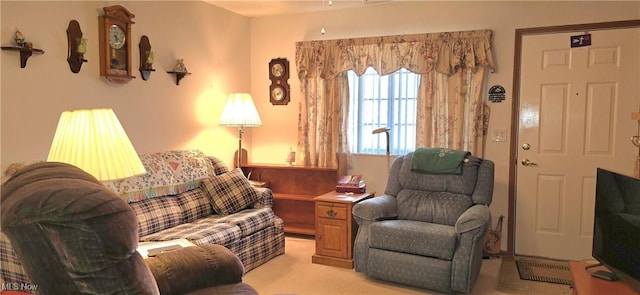 living area with light colored carpet