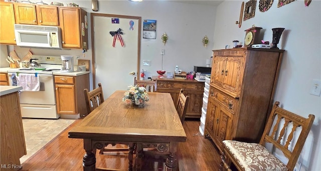 dining space with wood finished floors