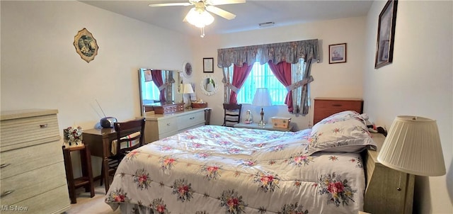 carpeted bedroom with ceiling fan and visible vents
