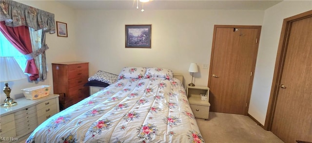 carpeted bedroom featuring baseboards