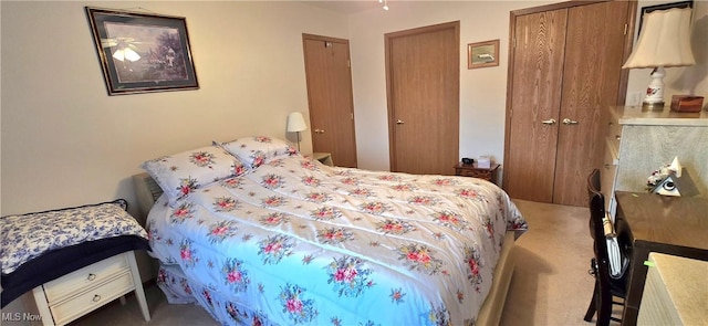 carpeted bedroom featuring two closets