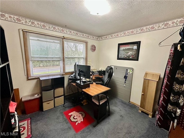 home office with a textured ceiling and carpet flooring