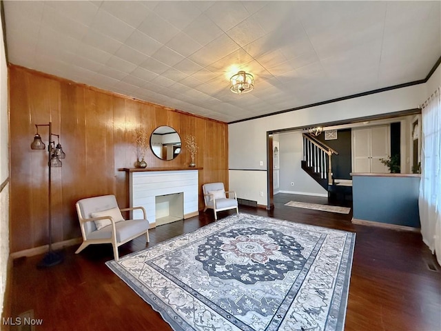 831 Fairview Ave, Parkersburg, WV 26101 - living area with baseboards, wooden walls, stairs, and wood finished floors