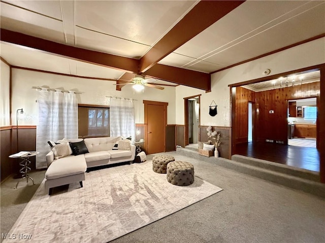 831 Fairview Ave, Parkersburg, WV 26101 - living room featuring a wainscoted wall, a ceiling fan, wood walls, beamed ceiling, and carpet