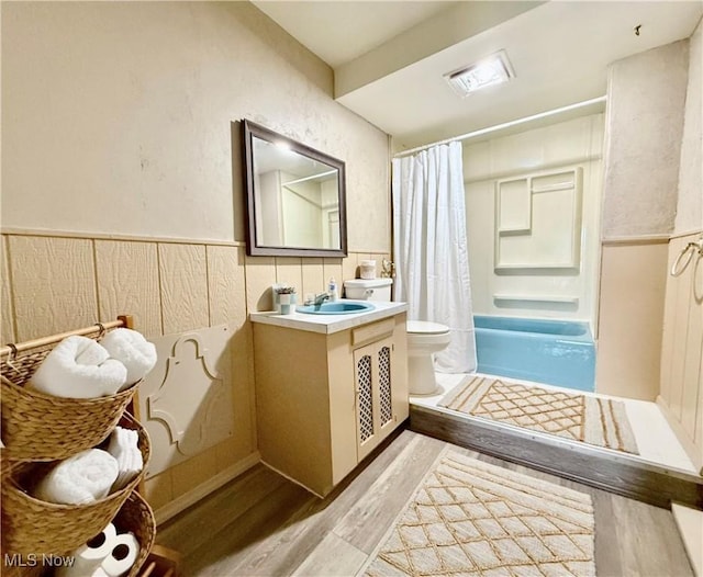 831 Fairview Ave, Parkersburg, WV 26101 - full bathroom with a wainscoted wall, toilet, vanity, a shower with curtain, and wood finished floors