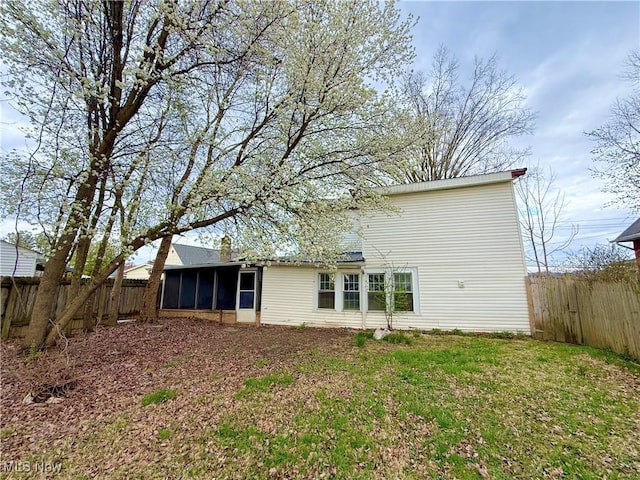 831 Fairview Ave, Parkersburg, WV 26101 - back of house featuring a fenced backyard, a sunroom, and a yard