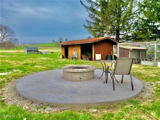 view of patio / terrace with an outbuilding and a fire pit