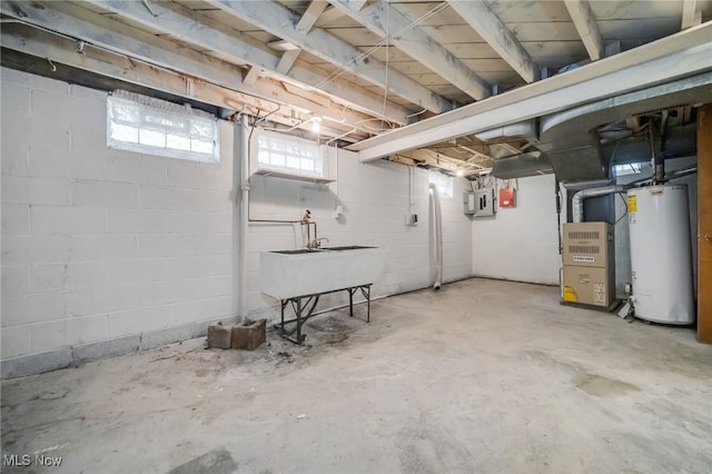 basement with heating unit, water heater, and a sink