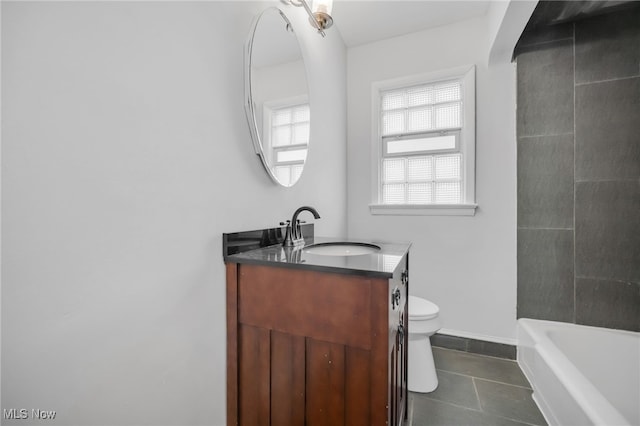 full bath with a bathtub, baseboards, toilet, vanity, and tile patterned flooring