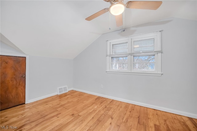 bonus room featuring vaulted ceiling, a ceiling fan, wood finished floors, baseboards, and visible vents