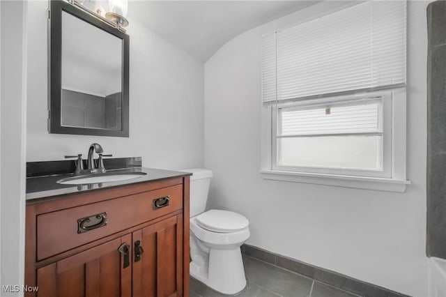 bathroom with tile patterned floors, toilet, baseboards, and vanity