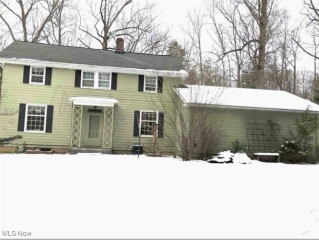 colonial inspired home with a chimney