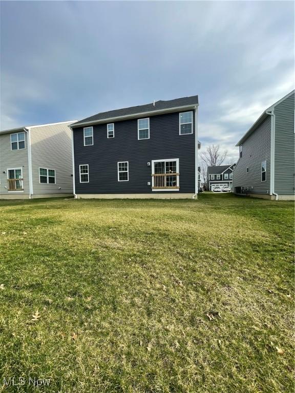 rear view of house with a lawn