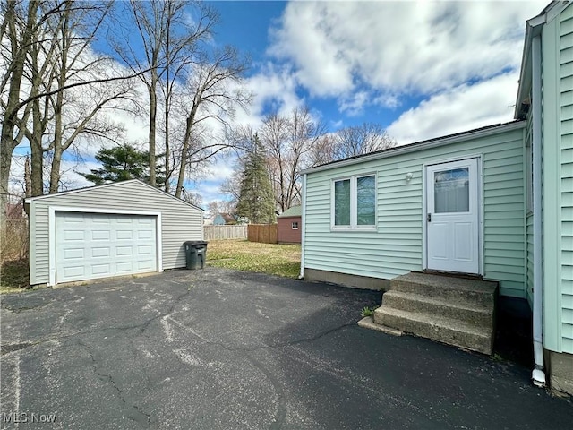 1563 Maplewood St NE, Warren, OH 44483 - detached garage featuring fence and aphalt driveway