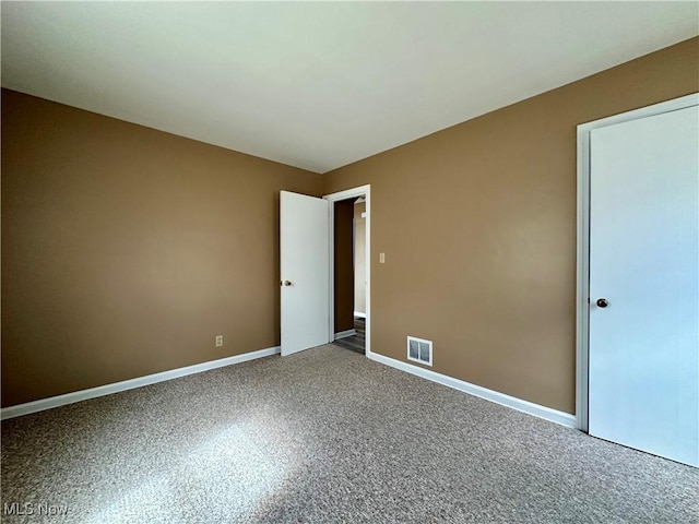 1563 Maplewood St NE, Warren, OH 44483 - spare room with baseboards, carpet flooring, and visible vents