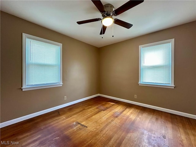1563 Maplewood St NE, Warren, OH 44483 - spare room with hardwood / wood-style floors, a ceiling fan, and baseboards