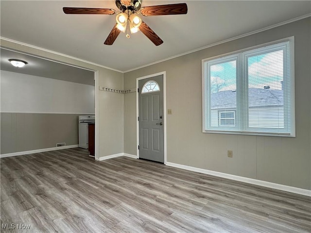 1563 Maplewood St NE, Warren, OH 44483 - foyer entrance with visible vents, wood finished floors, ornamental molding, and a ceiling fan