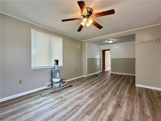 1563 Maplewood St NE, Warren, OH 44483 - unfurnished room with crown molding, baseboards, visible vents, ceiling fan, and wood finished floors
