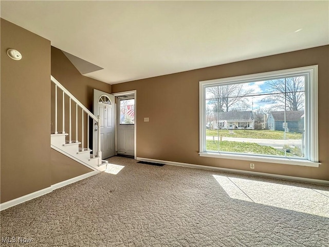1563 Maplewood St NE, Warren, OH 44483 - carpeted entrance foyer featuring baseboards, stairs, and visible vents