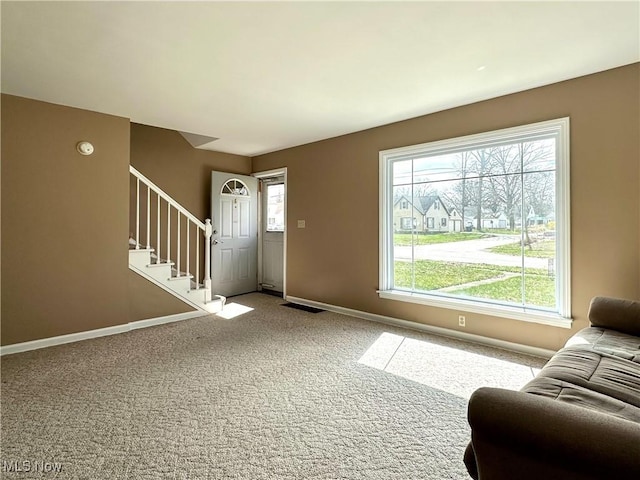 1563 Maplewood St NE, Warren, OH 44483 - carpeted living area with baseboards, stairs, and visible vents