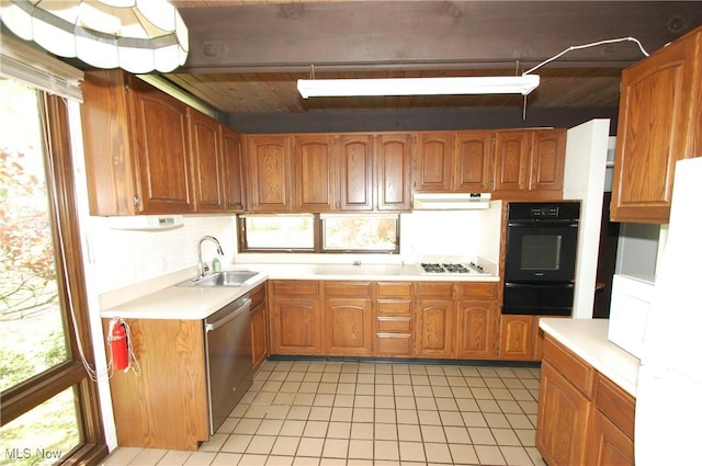 kitchen featuring white gas stovetop, stainless steel dishwasher, a sink, black oven, and a warming drawer