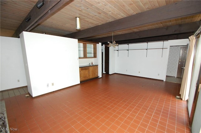 interior space with tile patterned floors, wood ceiling, baseboards, and beam ceiling