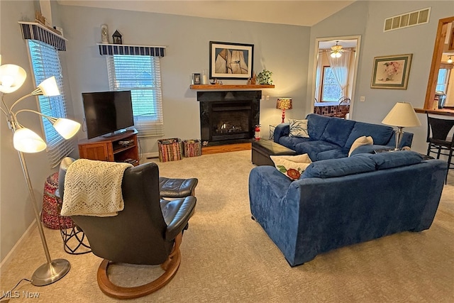 103 Southaven Ln, Kelleys Island, OH 43438 - living area with a fireplace, lofted ceiling, visible vents, ceiling fan, and carpet