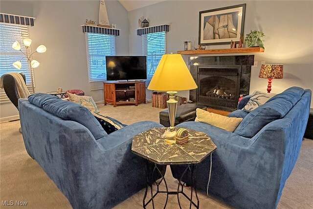 103 Southaven Ln, Kelleys Island, OH 43438 - living area featuring carpet floors, baseboards, a lit fireplace, and vaulted ceiling