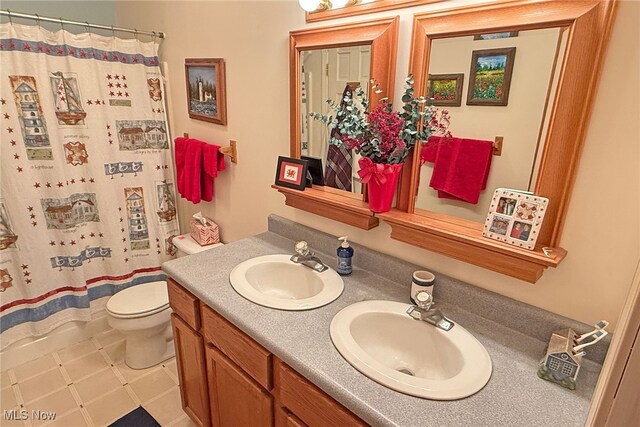 103 Southaven Ln, Kelleys Island, OH 43438 - bathroom with double vanity, a sink, toilet, and a shower with shower curtain