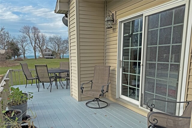 103 Southaven Ln, Kelleys Island, OH 43438 - wooden terrace featuring a lawn and outdoor dining area