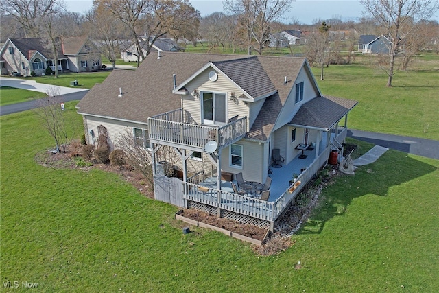 103 Southaven Ln, Kelleys Island, OH 43438 - exterior space with roof with shingles, a deck, a yard, and a residential view