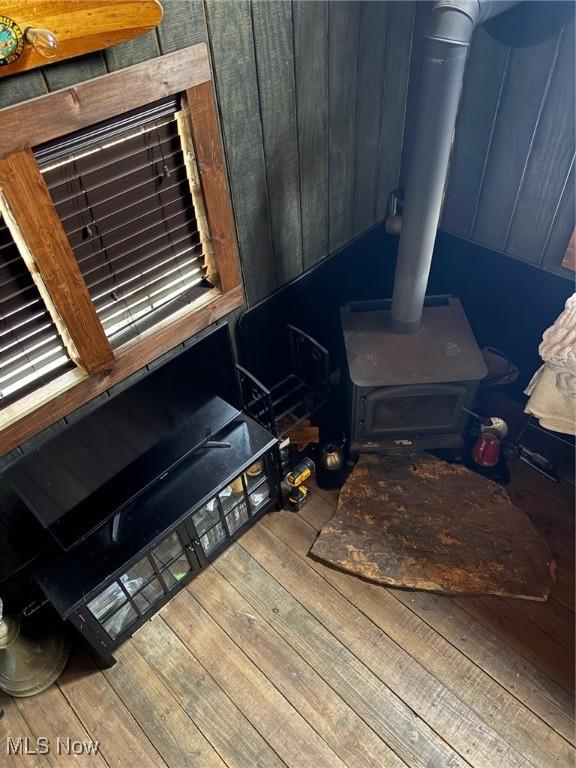 7301 Leafygreen St SW, Carrollton, OH 44615 - details featuring wood finished floors and a wood stove
