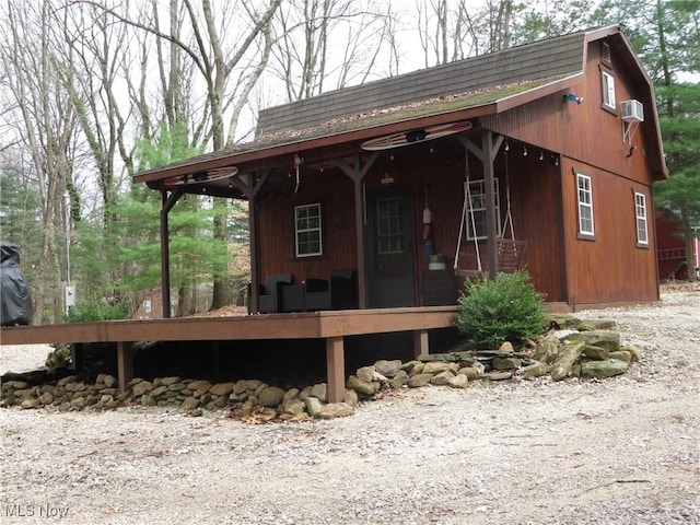 7301 Leafygreen St SW, Carrollton, OH 44615 - view of front of property featuring a porch, a gambrel roof, and a shingled roof