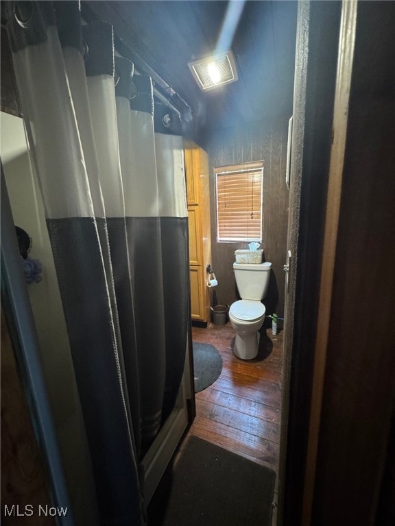 7301 Leafygreen St SW, Carrollton, OH 44615 - full bath with toilet, a stall shower, and hardwood / wood-style flooring