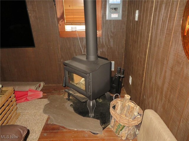 7301 Leafygreen St SW, Carrollton, OH 44615 - interior details with wooden walls and a wood stove