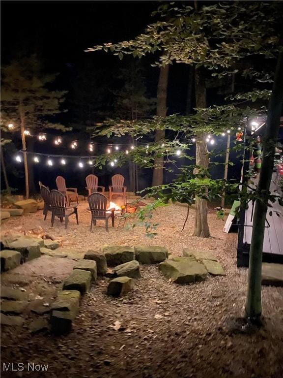 7301 Leafygreen St SW, Carrollton, OH 44615 - yard at night with an outdoor fire pit