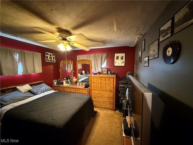 bedroom with light carpet, ceiling fan, and a textured ceiling