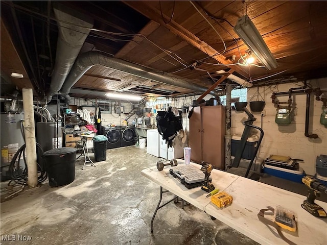 unfinished below grade area with washing machine and clothes dryer and water heater