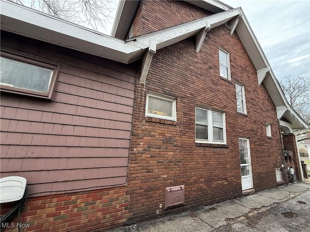 view of side of property featuring brick siding