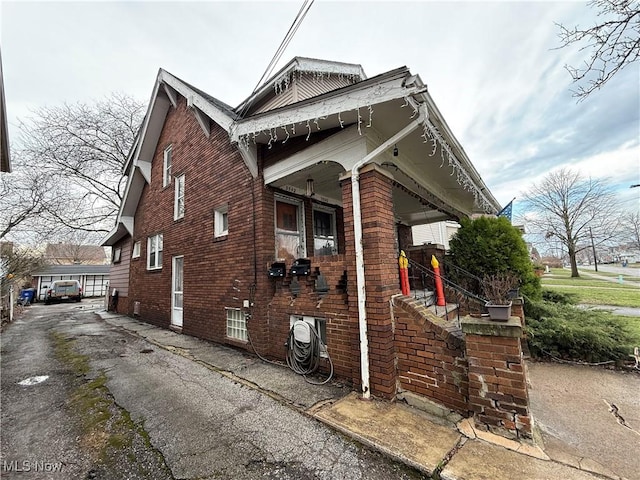 view of side of home featuring brick siding