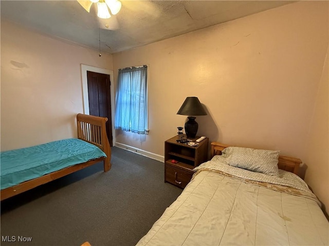 bedroom with baseboards and carpet