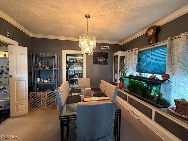 dining space featuring ornamental molding, a notable chandelier, a textured ceiling, and visible vents