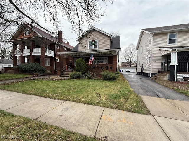 bungalow-style house with a front lawn