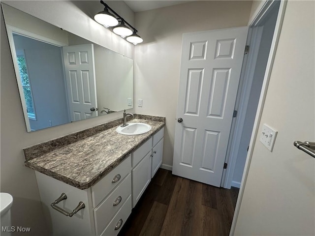 730 Mineral Springs Ave, Youngstown, OH 44511 - bathroom with wood finished floors, vanity, and baseboards