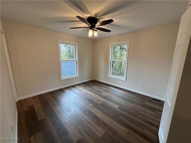 730 Mineral Springs Ave, Youngstown, OH 44511 - spare room featuring plenty of natural light, ceiling fan, baseboards, and dark wood-style floors
