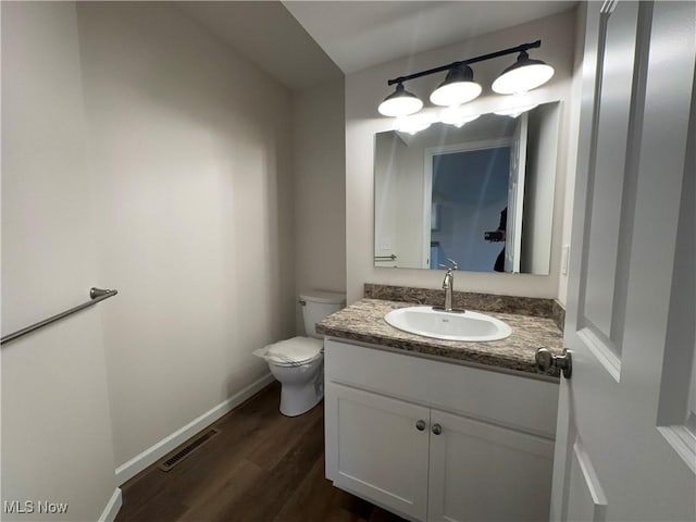 730 Mineral Springs Ave, Youngstown, OH 44511 - half bath featuring toilet, wood finished floors, vanity, and baseboards