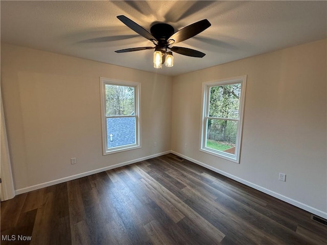 730 Mineral Springs Ave, Youngstown, OH 44511 - unfurnished room with healthy amount of natural light, baseboards, dark wood-type flooring, and ceiling fan